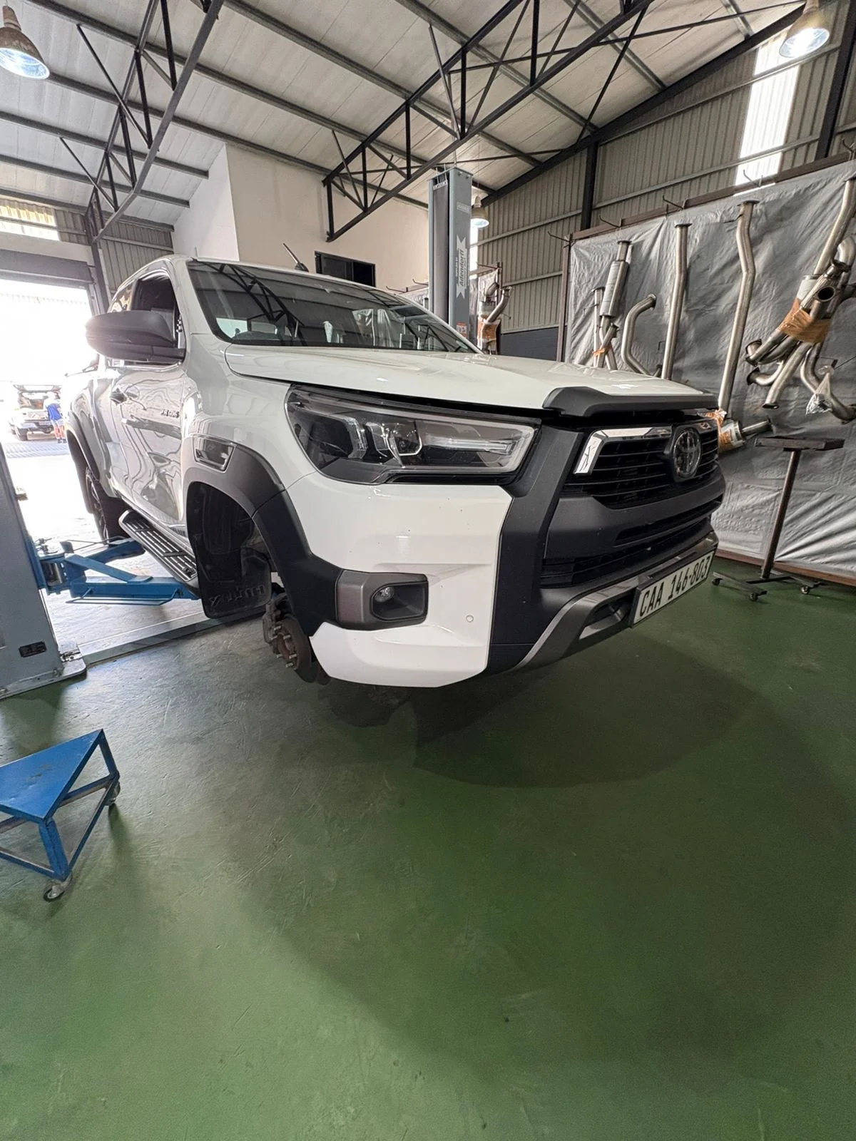 White pickup in the Kracht workshop during a Profender suspension installation