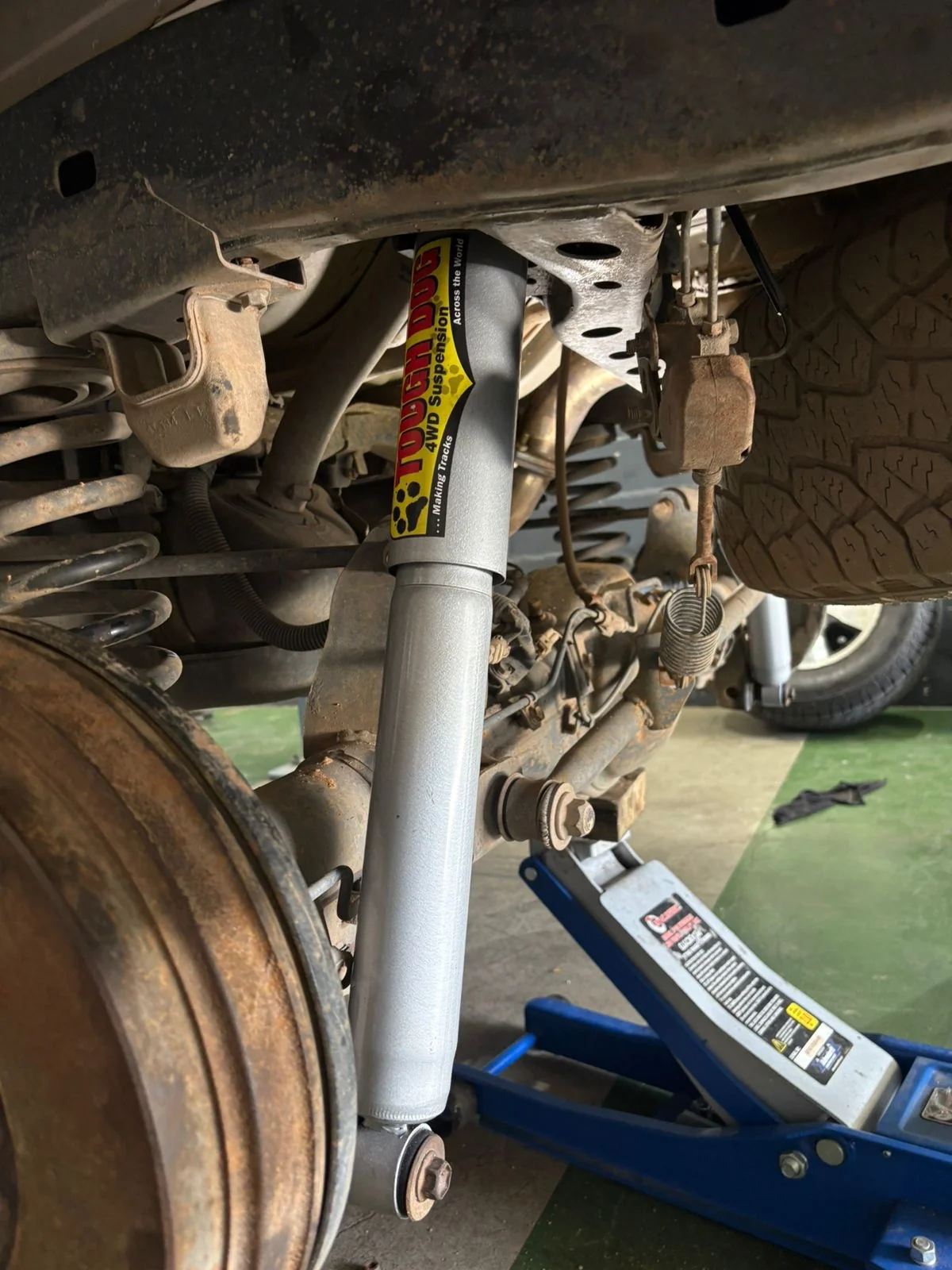 Tough Dog component fitted beneath a vehicle in the workshop